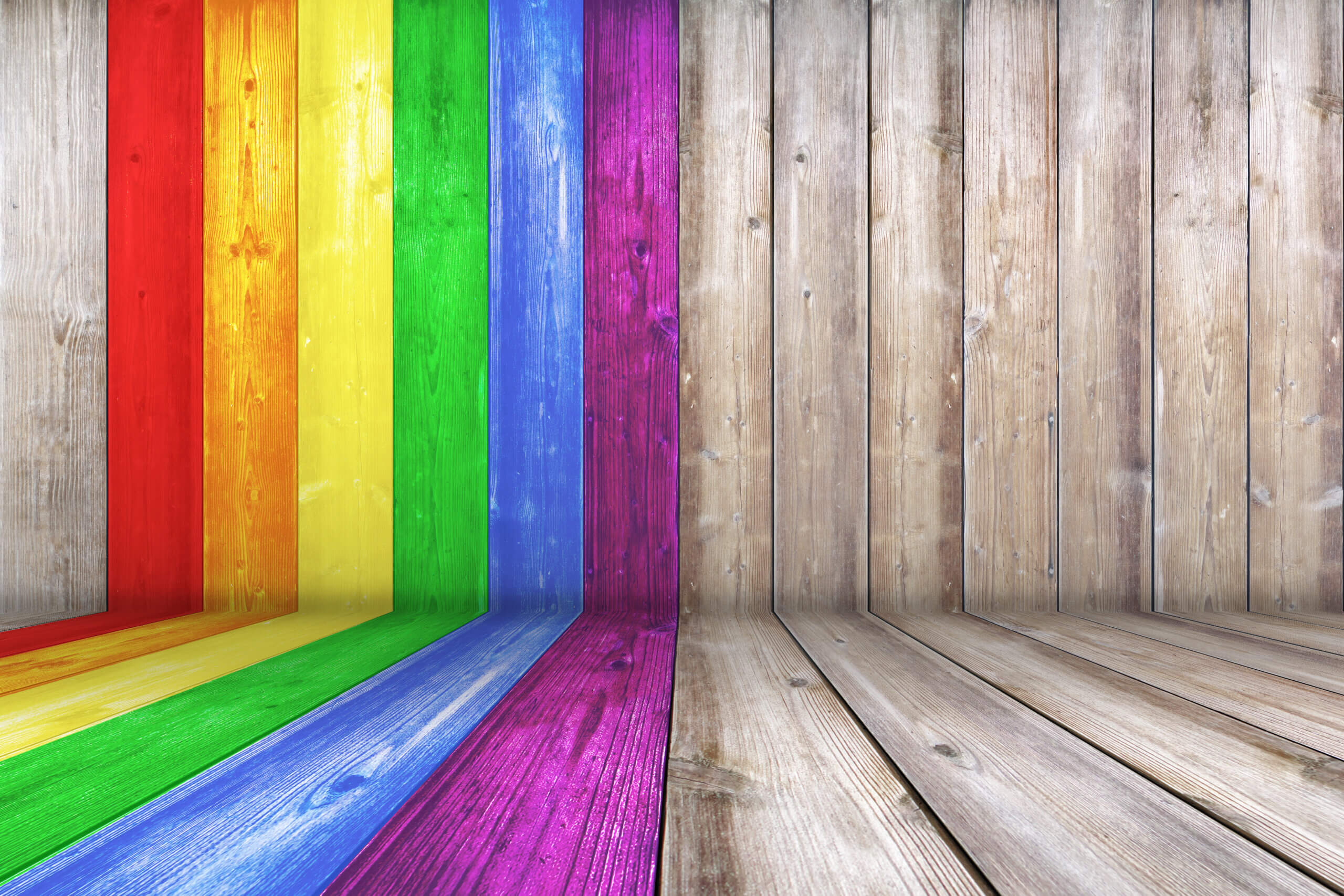 Reclaimed wood floor and wall painted in the colors of the LGBTQ PRIDE flag to welcome attendees of this Women's Coming Out Later in Life Support Group.